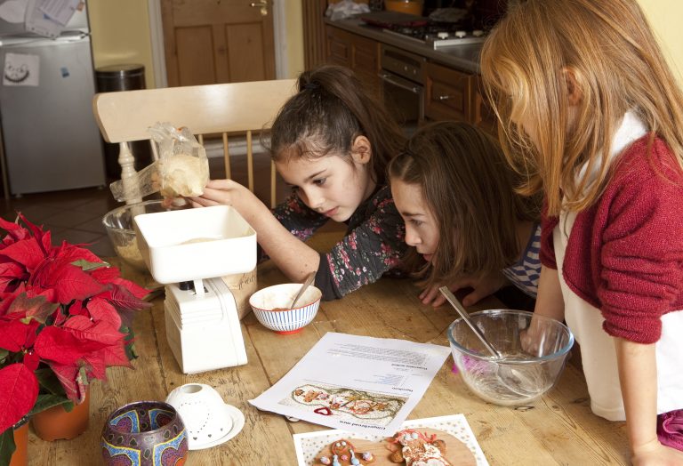 Young kids doing a recipe from book